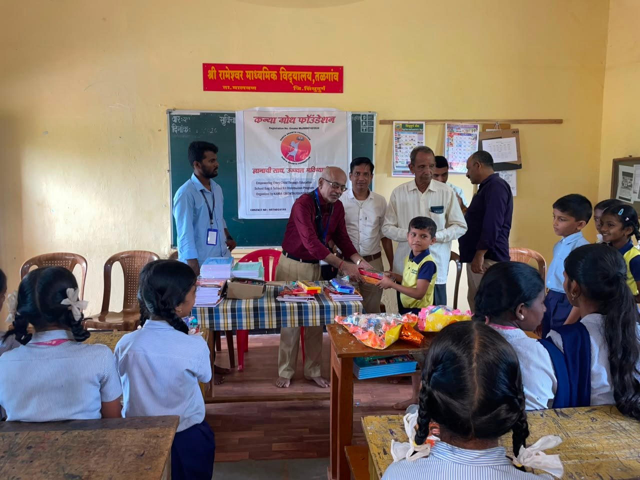 Students receiving school kits from Kanya Growth Foundation volunteers at a Konkan school