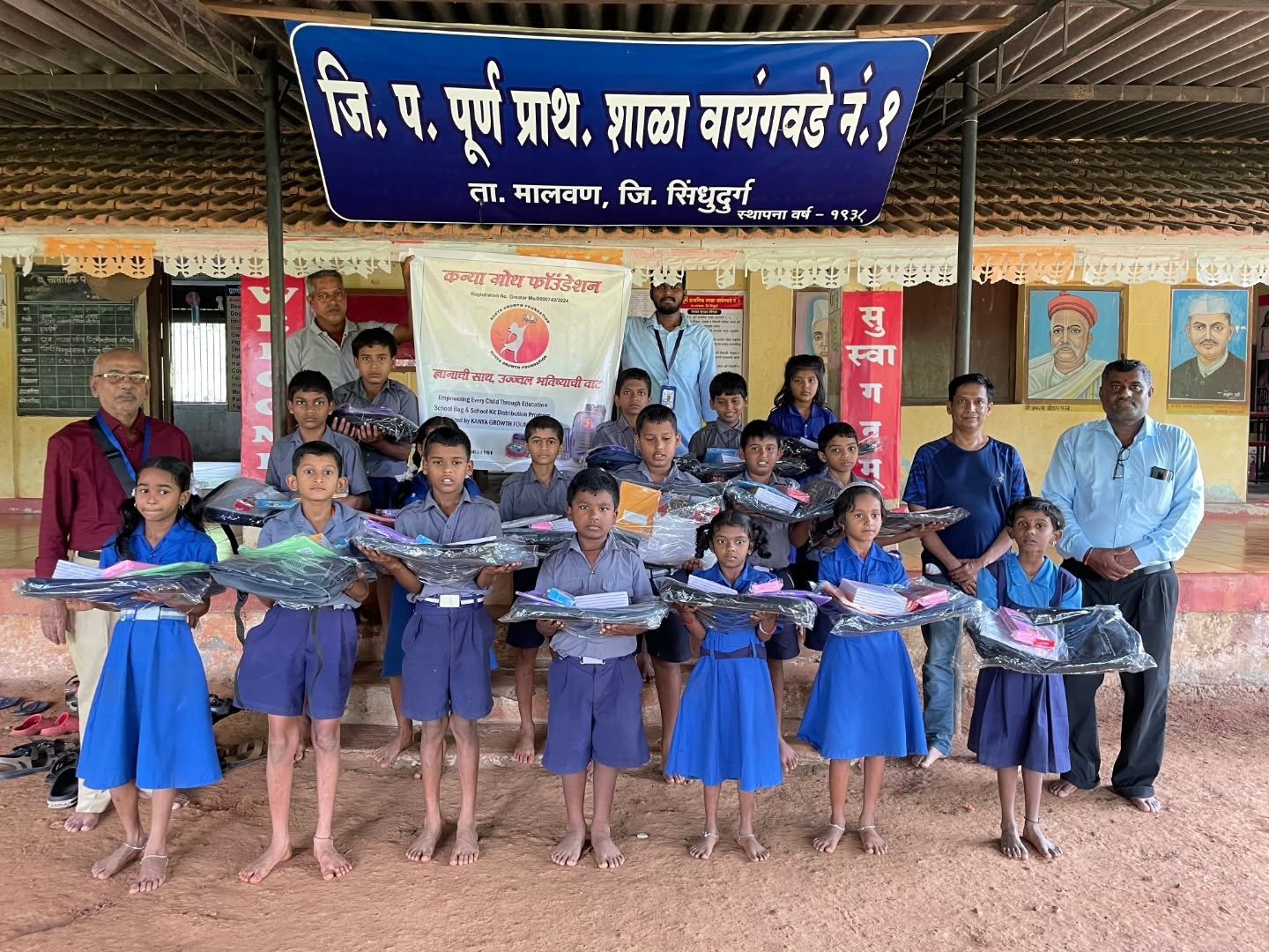 Children outside school with school bags and kits from Kanya Growth Foundation
